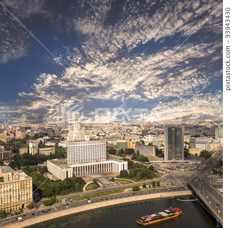 Aerial view of Moscow against the background of a romantic evening sky with clouds and rays of the sun. Government House of the Russian Federation (White House)-written in Russian, Russia Aerial view of Moscow against the background of a romantic evening sky with clouds and rays of the sun. Government House of the Russian Federation (White House)-written in Russian, Russia 93943430