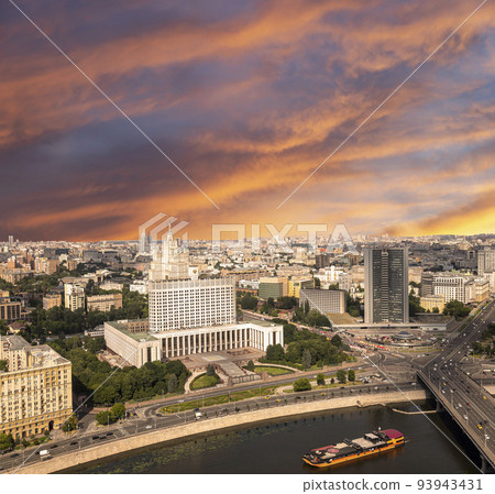 Aerial view of Moscow against the background of a romantic evening sky with clouds and rays of the sun. Government House of the Russian Federation (White House)-written in Russian, Russia Aerial view of Moscow against the background of a romantic evening sky with clouds and rays of the sun. Government House of the Russian Federation (White House)-written in Russian, Russia 93943431