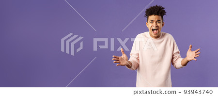 Portrait of concerned, upset and frustrated young man cant believe he lost, asking why, spread hands sideways in dismay, complaining shouting angry and uneasy, standing purple background Portrait of concerned, upset and frustrated young man cant believe he lost, asking why, spread hands sideways in dismay, complaining shouting angry and uneasy, standing purple background 93943740