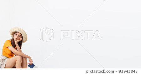 Lifestyle and travel Concept: Young beautiful caucasian woman is sitting on suitecase and waiting for her flight.Isolated over white background Lifestyle and travel Concept: Young beautiful caucasian woman is sitting on suitecase and waiting for her flight.Isolated over white background 93943845