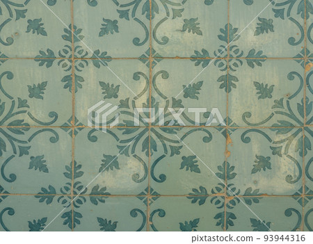 Green ceramic tiles from facade of old houses in Lisbon Portugal. Portuguese traditional Azulejos decorative artistic design background, creative texture surface Green ceramic tiles from facade of old houses in Lisbon Portugal. Portuguese traditional Azulejos decorative artistic design background, creative texture surface 93944316