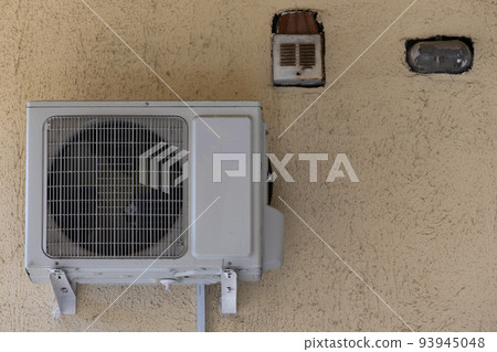 old air conditioning refrigeration unit outside the building 93945048