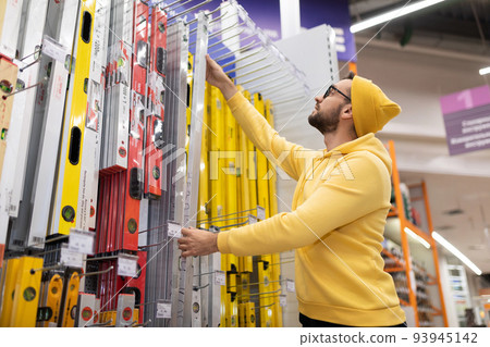 young man buys a building bubble level young man buys a building bubble level 93945142