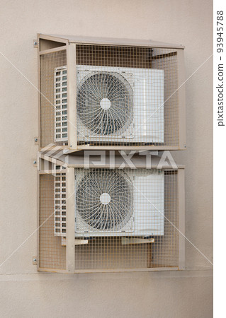 cooling unit for duct air conditioner hanging on the wall of the building 93945788