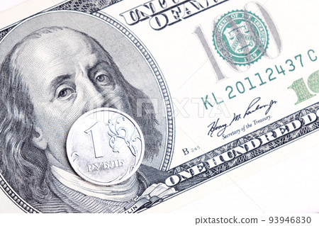 Metal coin 1 Russian ruble lies on 100 US dollars. A crisis. Economy Currency exchange. concept Metal coin 1 Russian ruble lies on 100 US dollars. A crisis. Economy Currency exchange. concept 93946830