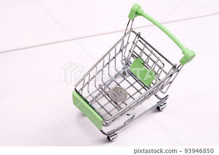 Empty mini shopping cart on the table, top view Empty mini shopping cart on the table, top view 93946850