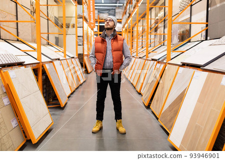 a man in a ceramic tile shop chooses materials for his home a man in a ceramic tile shop chooses materials for his home 93946901