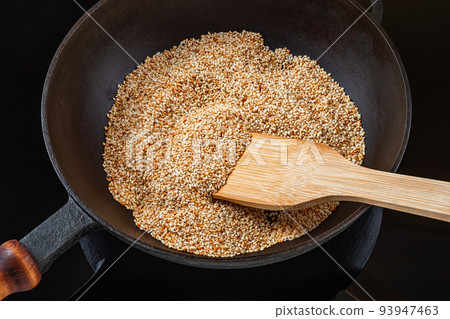 Toasting sesame seeds in a cast iron skillet.  93947463