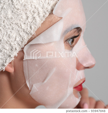 Facial skin care, portrait of a young woman with a mask on her face. Facial skin care, portrait of a young woman with a mask on her face. 93947848