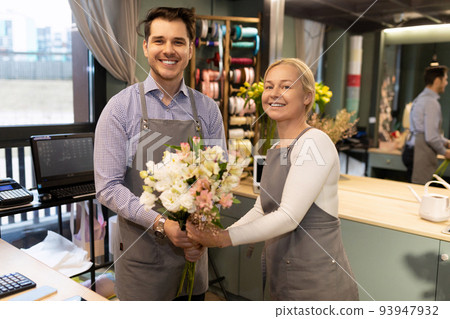 endearing smiling florist in a flower shop from fresh bouquets endearing smiling florist in a flower shop from fresh bouquets 93947932