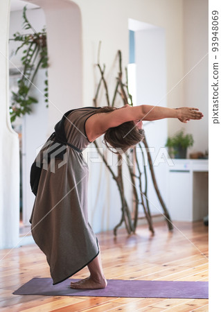Yogi woman practicing yoga lesson, doing hastauttanasana or upward salute 93948069