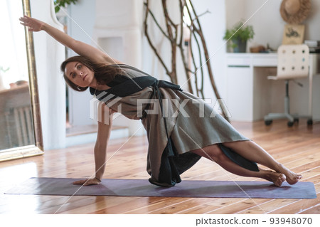 Caucasian sporty woman doing yoga pose or side plank. Caucasian sporty woman doing yoga pose or side plank. 93948070
