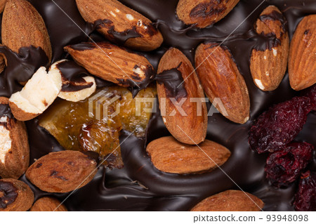 texture of natural dark dark chocolate with wild berries and whole roasted almonds texture of natural dark dark chocolate with wild berries and whole roasted almonds 93948098