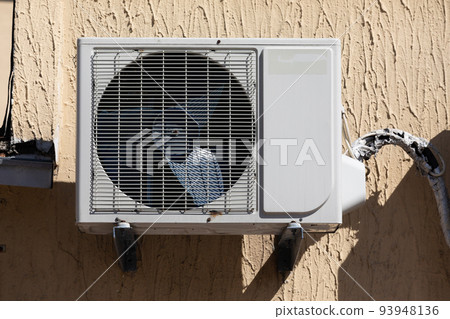 outdoor air conditioner unit on the wall of a building 93948136