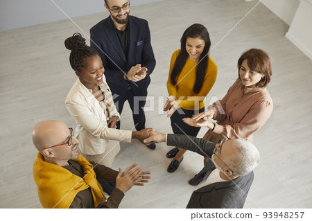 Smiling diverse businesspeople handshake close deal 93948257