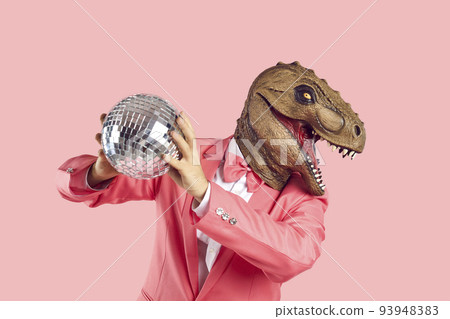Man in rubber dinosaur mask gold disco ball 93948383