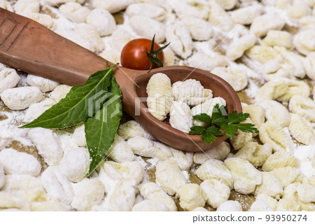 Homemade gnocchi, prepared on the table with ingredients. Homemade gnocchi, prepared on the table with ingredients. 93950274