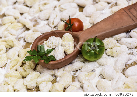 Homemade gnocchi, prepared on the table with ingredients. Homemade gnocchi, prepared on the table with ingredients. 93950275