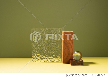 Creative abstract podium made of wooden figures and glass, dark green background hard light shadow Creative abstract podium made of wooden figures and glass, dark green background hard light shadow 93950724