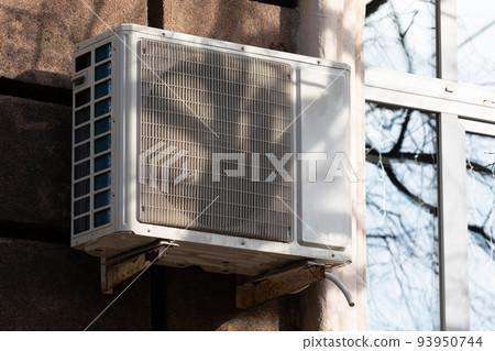 outdoor air conditioner unit with heat exchanger hanging outside the building outdoor air conditioner unit with heat exchanger hanging outside the building 93950744