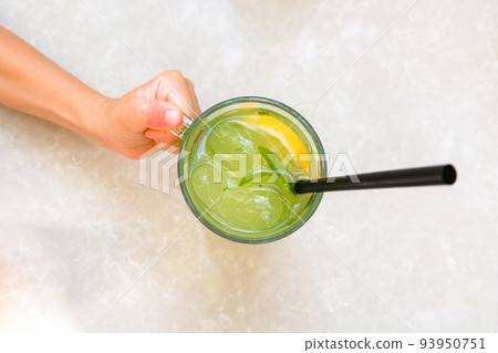 Fresh lemonade or mojito cocktail with mint on the table. Fresh lemonade or mojito cocktail with mint on the table. 93950751