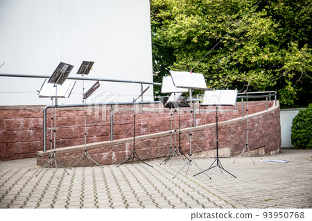 Many music stands for an orchestra in the open air Many music stands for an orchestra in the open air 93950768