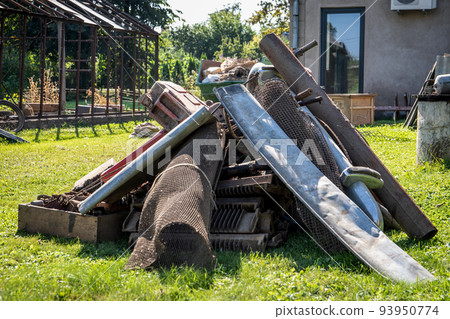 Scrap metal collection. Dirty backyard. Pickers and collectors 93950774