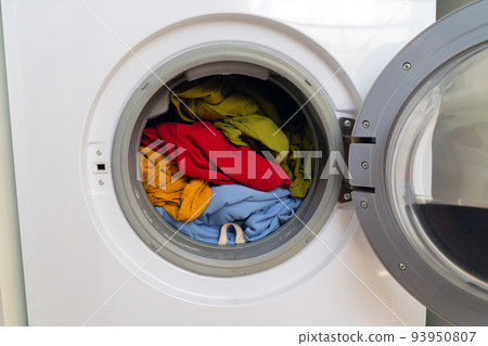 Bright clothes inside washing machine. Bright clothes inside washing machine. 93950807