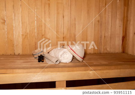 Traditional old Russian bathhouse SPA Concept. Interior details Finnish sauna steam room with traditional sauna accessories set basin towel aroma oil scoop felt. Relax country village bath concept Traditional old Russian bathhouse SPA Concept. Interior details Finnish sauna steam room with traditional sauna accessories set basin towel aroma oil scoop felt. Relax country village bath concept 93951115