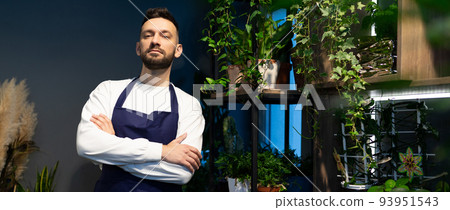 portrait of an experienced gardener in a shop selling potted plants portrait of an experienced gardener in a shop selling potted plants 93951543