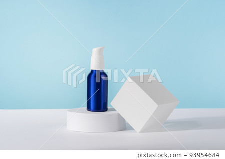 Cosmetic cream metallic pump bottle mockup on blue background with stylish props on white geometrical pedestal podium. Unbranded lotion beauty product packaging. Product presentation Cosmetic cream metallic pump bottle mockup on blue background with stylish props on white geometrical pedestal podium. Unbranded lotion beauty product packaging. Product presentation 93954684