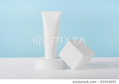 Cosmetic luxury cream tube bottle mockup on blue background on pedestal podium. Unbranded lotion beauty product packaging. Product presentation mock up. Lotion, mousse, cleanser for skincare Cosmetic luxury cream tube bottle mockup on blue background on pedestal podium. Unbranded lotion beauty product packaging. Product presentation mock up. Lotion, mousse, cleanser for skincare 93954685