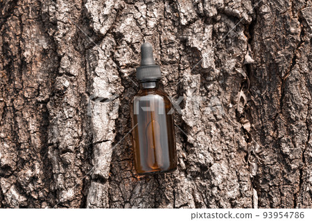 Serum oil in amber glass cosmetic bottle on tree bark top view. Anti aging serum with collagen and peptide. Organic science concept. Skincare beauty product 93954786