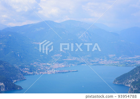 Aerial view of mountain lake Iseo, forested mountains, various villages scattered along the slopes and along the coast. Picturesque summer landscape. Aerial view of mountain lake Iseo, forested mountains, various villages scattered along the slopes and along the coast. Picturesque summer landscape. 93954788