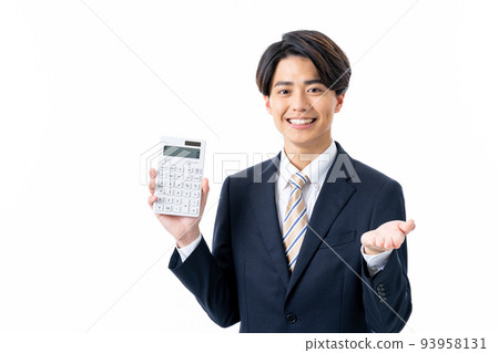 A young businessman with a calculator 93958131