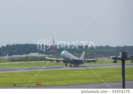 A white jumbo cargo plane taking off from the runway of Narita Airport into the white sky taken from the Aviation Museum A white jumbo cargo plane taking off from the runway of Narita Airport into the white sky taken from the Aviation Museum 93958276