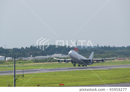 A white jumbo cargo plane taking off from the runway of Narita Airport into the white sky taken from the Aviation Museum A white jumbo cargo plane taking off from the runway of Narita Airport into the white sky taken from the Aviation Museum 93958277