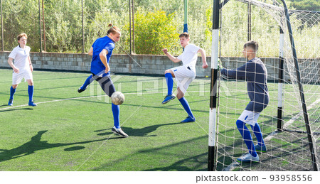 Youthful football players challenging for ball Youthful football players challenging for ball 93958556