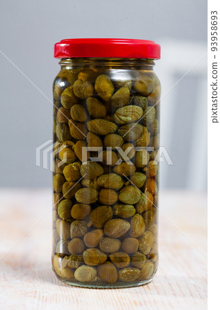 Glass jar with pickled capers 93958693