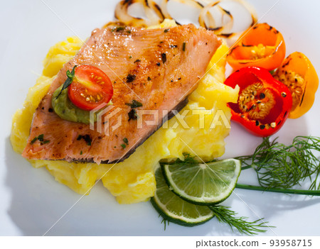 Grilled fillet of trout with potato mash and vegetables 93958715