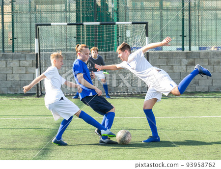 Young football players fighting for ball 93958762