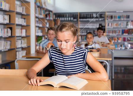 Schoolers reading in college library Schoolers reading in college library 93958795