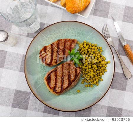 Popular all over the world dish of appetizing fried beef steak, subject with green peas Popular all over the world dish of appetizing fried beef steak, subject with green peas 93958796