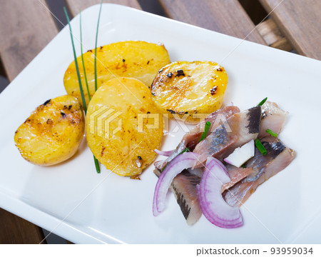 Pickled herring with pieces of potatoes 93959034