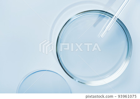Empty round petri dish or glass slide and Pipette on blue background. Mockup for cosmetic or scientific product sample 93961075