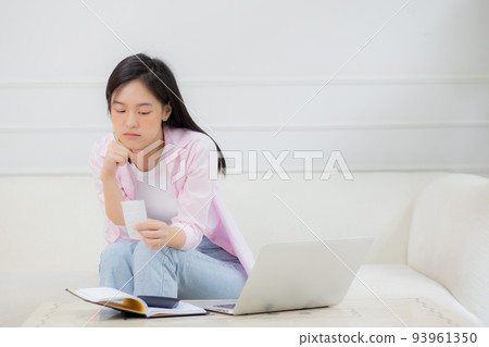 Young asian woman calculating expenses household about finance and frustrated at home. Young asian woman calculating expenses household about finance and frustrated at home. 93961350