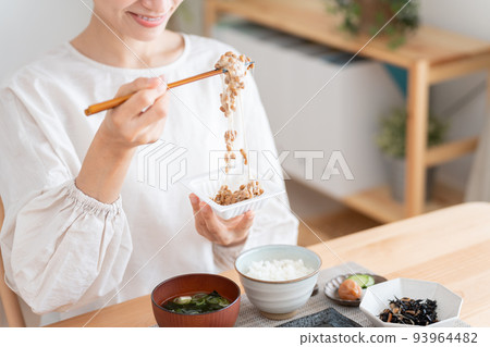 Middle woman mixing natto for breakfast Middle woman mixing natto for breakfast 93964482