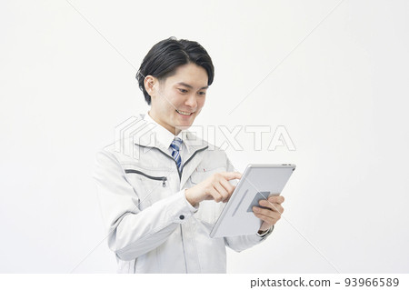 Worker using a tablet on a white background Worker using a tablet on a white background 93966589