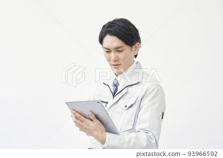 A worker working with a tablet on a white background 93966592