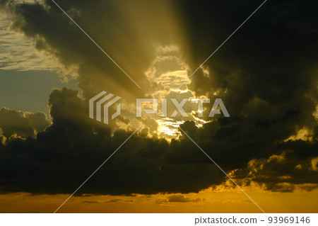 Very ominous thunderstorm clouds before a thunderstorm with sun rays. 93969146
